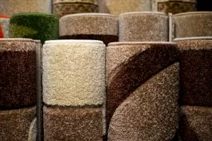 Colorful Collection Of Carpets And Rugs Folded And Displayed In Store
